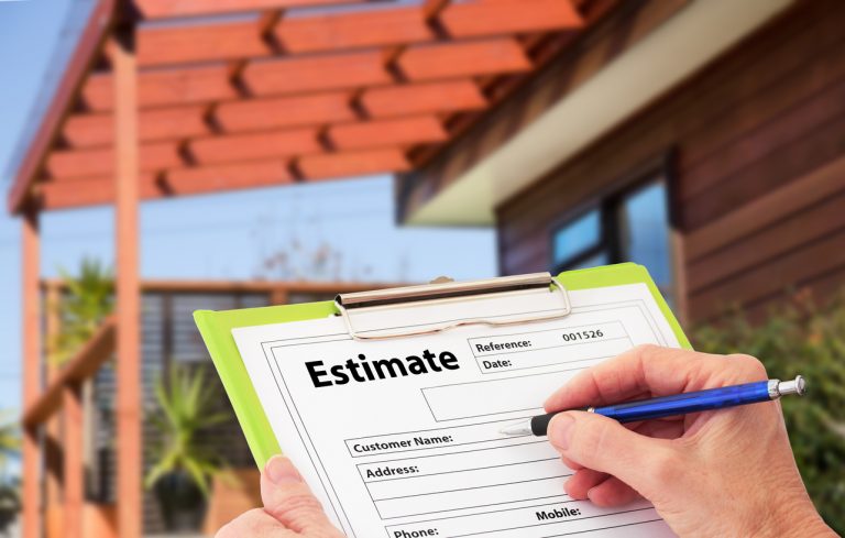 Hand writing an estimate on a clipboard for Home Building Renovation
