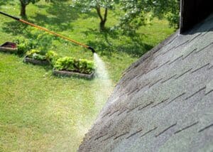 Spraying chemical on home roof
